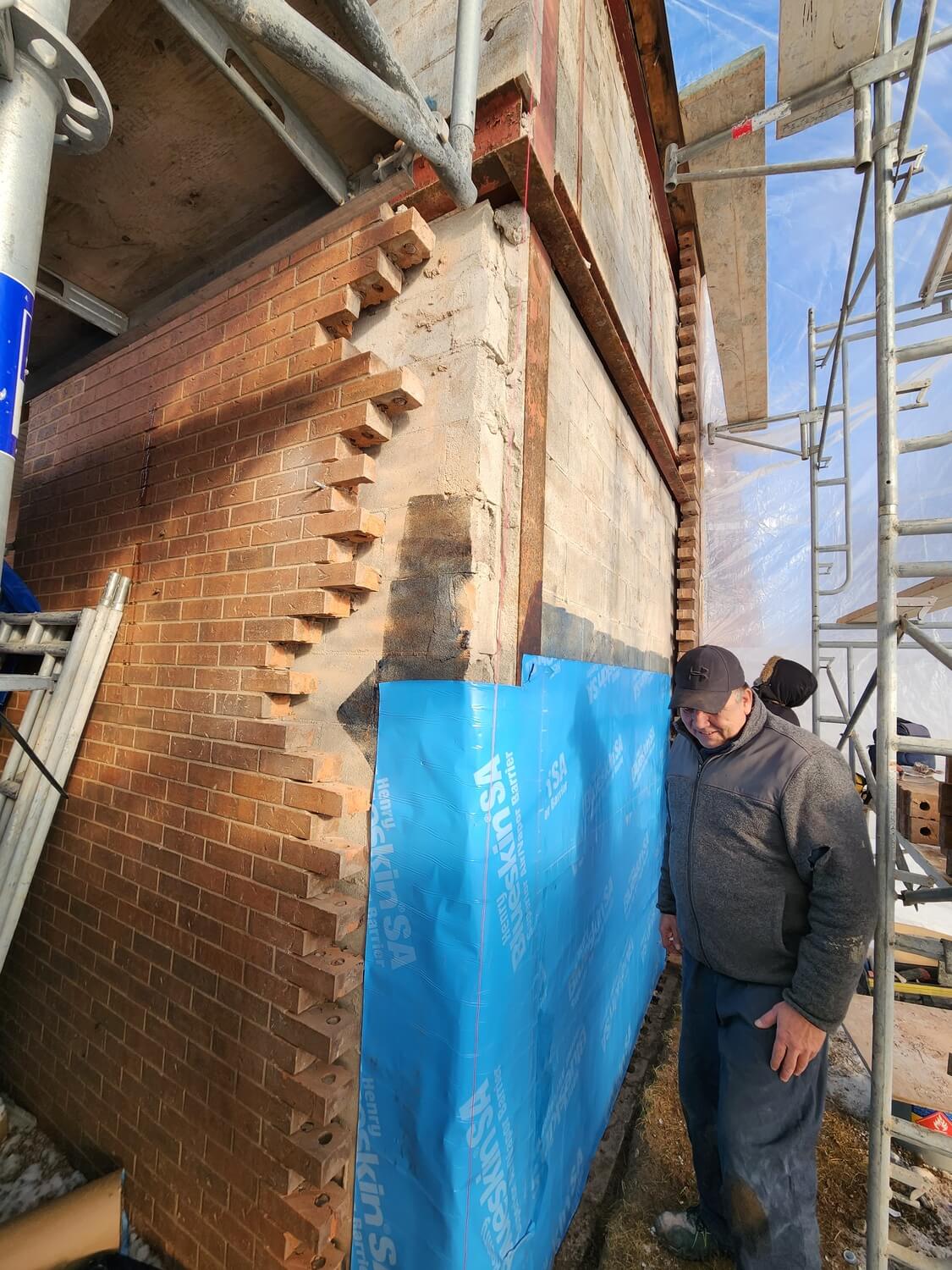 Mason toothing in new brick to match an existing wall