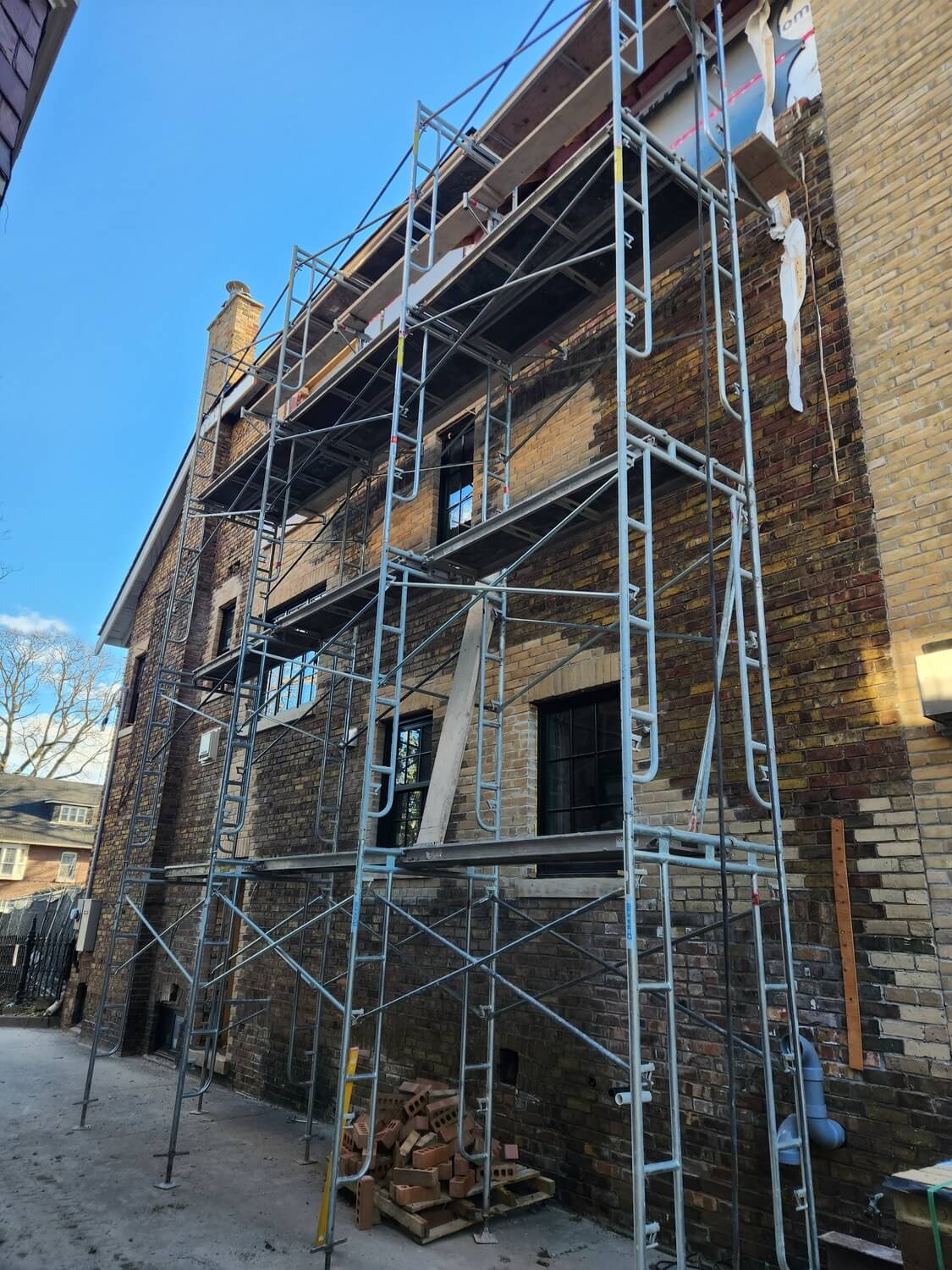 Full-height scaffold repoint on a three-storey facade