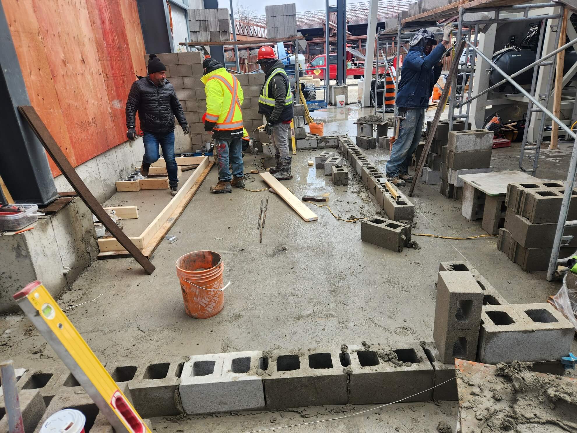 Crew laying concrete block on a commercial site